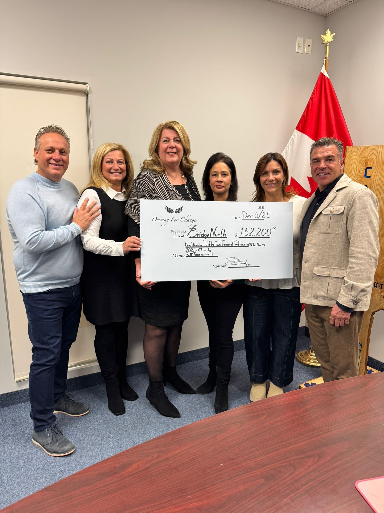 Driving for Change presents BridgeNorth with a $152,200 donation cheque, December 2025
