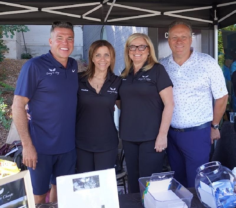The Driving For Change team under the tournament tent